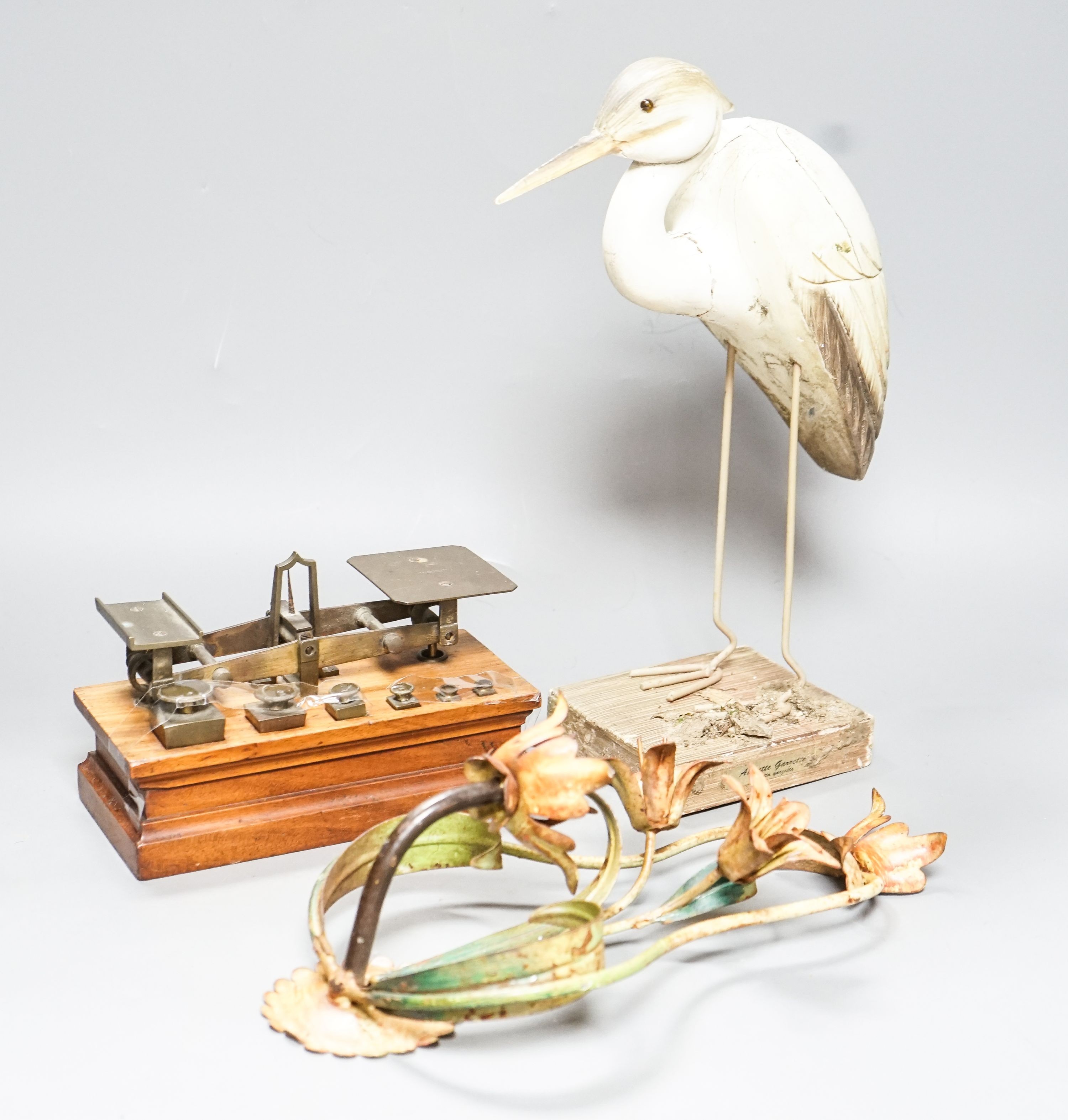 A Ratcliff weighing scale, a painted wrought iron floral wall light, a model of a stork, 33cm